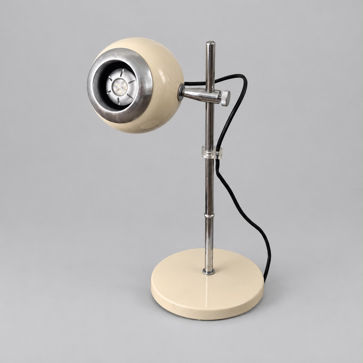 Cream eyeball desk lamp on a chrome stem